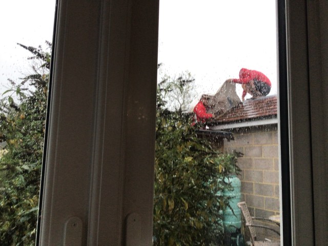 builders on the roof outside